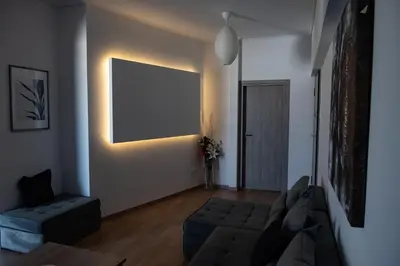 a living room with a couch and a chair at Renovated apartment 5min from subway station 'Attiki' in Athens
