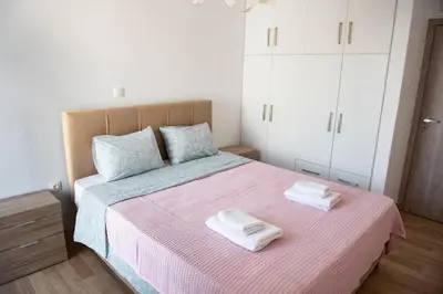a bedroom with a bed with two towels on it at Renovated apartment 5min from subway station 'Attiki' in Athens