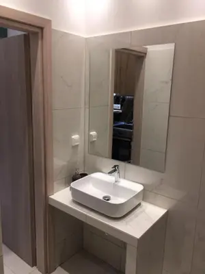 a bathroom with a white sink and a mirror at LUXURY IPOGA in Athens