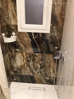 a bathroom with a sink and a shower with a mirror at LUXURY IPOGA in Athens