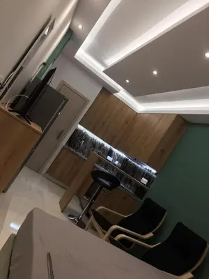 a view of a kitchen with a counter and two chairs at LUXURY IPOGA in Athens