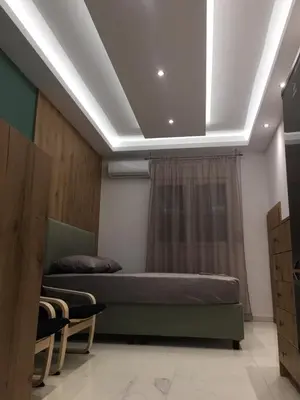 a bedroom with two beds and a ceiling with a window at LUXURY IPOGA in Athens