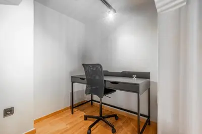 a black desk with a chair in a room at Industrial Rental Loft in Athens