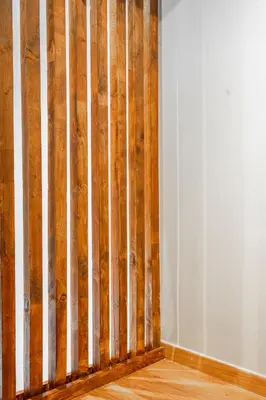 a wooden fence in the corner of a room at Industrial Rental Loft in Athens