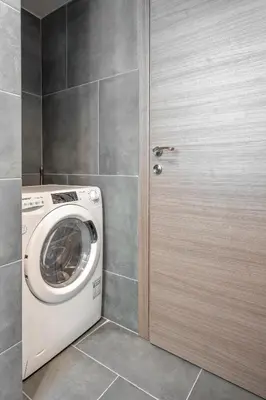 a washing machine in a bathroom next to a door at Industrial Rental Loft in Athens