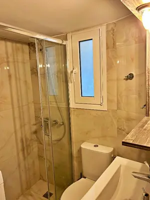 a bathroom with a shower and a toilet and a sink at Apollonion Luxury Apartment near the metro station in Athens
