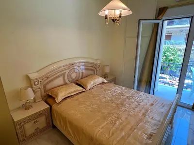 a bedroom with a large bed and a window at Apollonion Luxury Apartment near the metro station in Athens