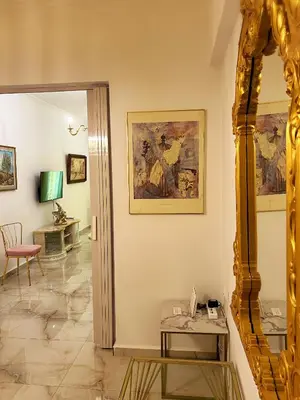 a room with a table and a painting on the wall at Apollonion Luxury Apartment near the metro station in Athens