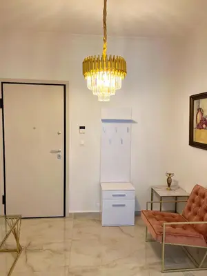 a living room with a chandelier and a couch at Apollonion Luxury Apartment near the metro station in Athens