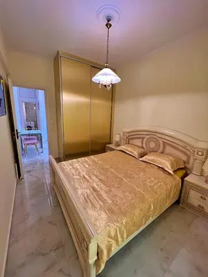 a bedroom with a bed and a chandelier at Apollonion Luxury Apartment near the metro station in Athens