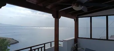 a view of the water from a balcony of a house at Blue Seaview Suites in Piraeus