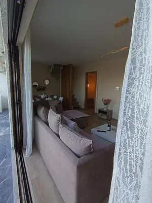 a living room with a couch with pillows at Blue Seaview Suites in Piraeus