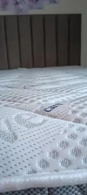 a close up of a white bedsheet on a bed at Blue Seaview Suites in Piraeus