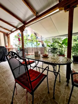 a patio with a table and chairs on a porch at Large terrace apartment near city centre in Athens