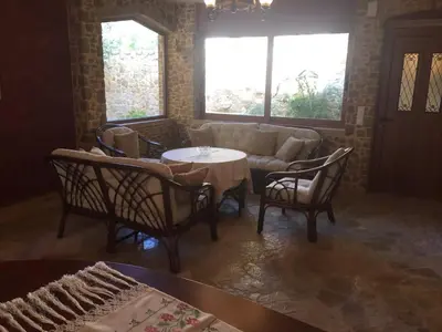a living room with a couch and a table and chairs at Platanus Gardenhouse in Anavissos