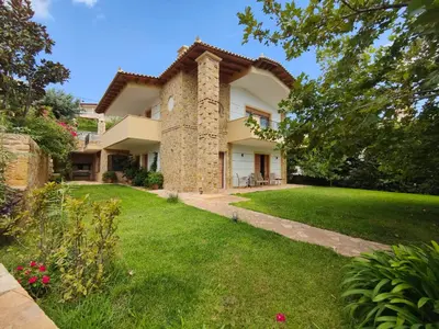 an exterior view of a house with a yard at Platanus Gardenhouse in Anavissos