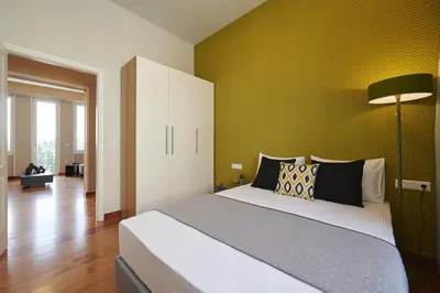 a bedroom with a large bed and a green wall at Ma Maison No7 Acropolis View Mansion, Roof Garden in Athens