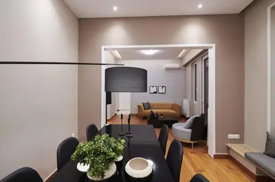 a dining room with a table and a living room at Ma Maison No7 Acropolis View Mansion, Roof Garden in Athens