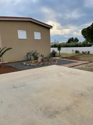 a house with a driveway in front of it at Saint George family house in Palaiá Fókaia