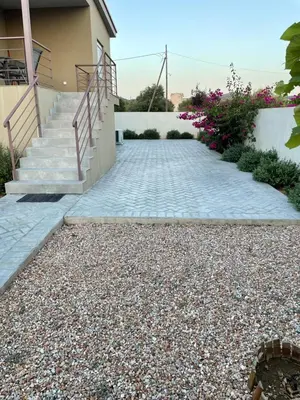 a stone walkway leading to a house with stairs at Saint George family house in Palaiá Fókaia