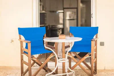 two blue chairs and a table in a kitchen at ANO PATISIA STUDIO (ΑΓΙΟΣ ΕΛΕΥΘΕΡΙΟΣ) in Athens