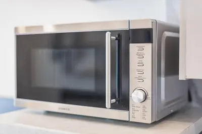 a microwave oven sitting on top of a counter at ANO PATISIA STUDIO (ΑΓΙΟΣ ΕΛΕΥΘΕΡΙΟΣ) in Athens