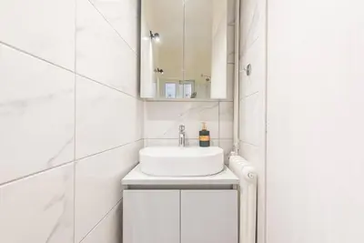 a white bathroom with a sink and a mirror at ANO PATISIA STUDIO (ΑΓΙΟΣ ΕΛΕΥΘΕΡΙΟΣ) in Athens