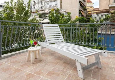 a white bench sitting on top of a balcony at Skyhi Athens Penthouse ! in Athens