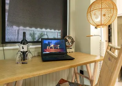 a laptop computer sitting on top of a wooden table at Skyhi Athens Penthouse ! in Athens