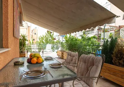 a table with fruit on it on a balcony at Skyhi Athens Penthouse ! in Athens