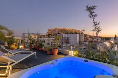 a hot tub on the roof of a building at Meno Suite with Private Terrace - Jaccuzzi, Acropolis View in Athens