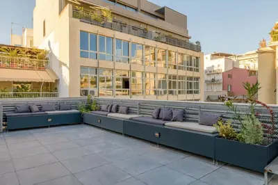 a row of benches in front of a building at Meno Suite with Private Terrace - Jaccuzzi, Acropolis View in Athens