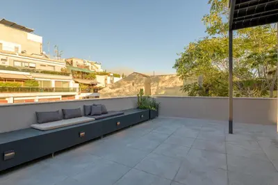 a patio with benches on the side of a building at Meno Suite with Private Terrace - Jaccuzzi, Acropolis View in Athens