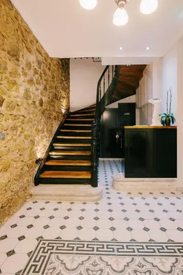 a staircase in a building with a tiled floor at Neapolis 1897 Boutique Luxury Rooms in Athens