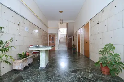 a hallway with a table and plants in a building at Studio in the heart of Athens, next to Metro &... in Athens