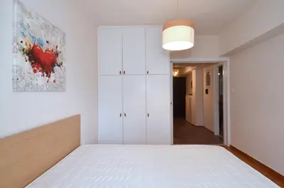 a bedroom with a bed and a white cabinet at Studio in the heart of Athens, next to Metro &... in Athens