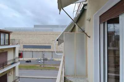 a balcony with an umbrella and a view of a parking lot at Studio in the heart of Athens, next to Metro &... in Athens