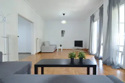 a living room with a couch and a table at A spacious minimal apatment at Chalandri in Athens