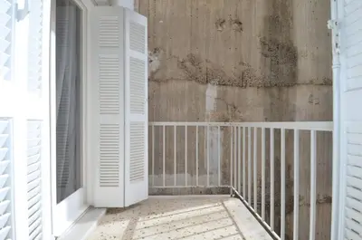 a room with a white door and a wall at A cozy minimal apartment at Koukaki, Dimitrako... in Athens