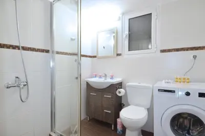 a bathroom with a toilet and a sink and a shower at A cozy minimal apartment at Koukaki, Dimitrako... in Athens
