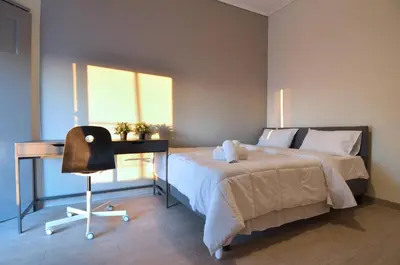 a bedroom with a bed and a desk and a chair at A minimal retire at Kypseli with an amazing view in Athens