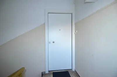 an empty room with a door in the corner at A minimal retire at Kypseli with an amazing view in Athens