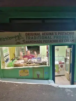 a sign in the window of a pastry shop at Ammoudia Rooms in Agia Marina Aegina