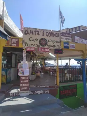 a building that has signs on the side of it at Ammoudia Rooms in Agia Marina Aegina