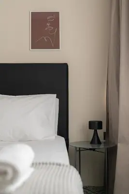 a bedroom with a bed and a side table at The Artisan Suites in Athens