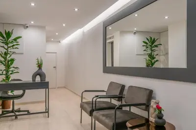 a waiting room with two chairs and a mirror at The Artisan Suites in Athens