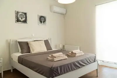 a bedroom with a bed with towels on it at Blue Dreams - Spectacular Sea View Apartment in Athens in Athens