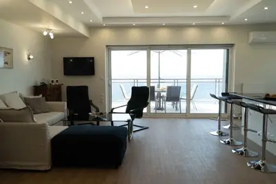 a living room with a couch and a table at Blue Dreams - Spectacular Sea View Apartment in Athens in Athens
