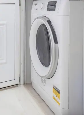 a white washing machine sitting in a room at Koukaki Spacious Penthouse with parking for Small Car in Athens