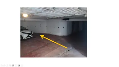 a parking garage with a yellow arrow on the floor at Koukaki Spacious Penthouse with parking for Small Car in Athens